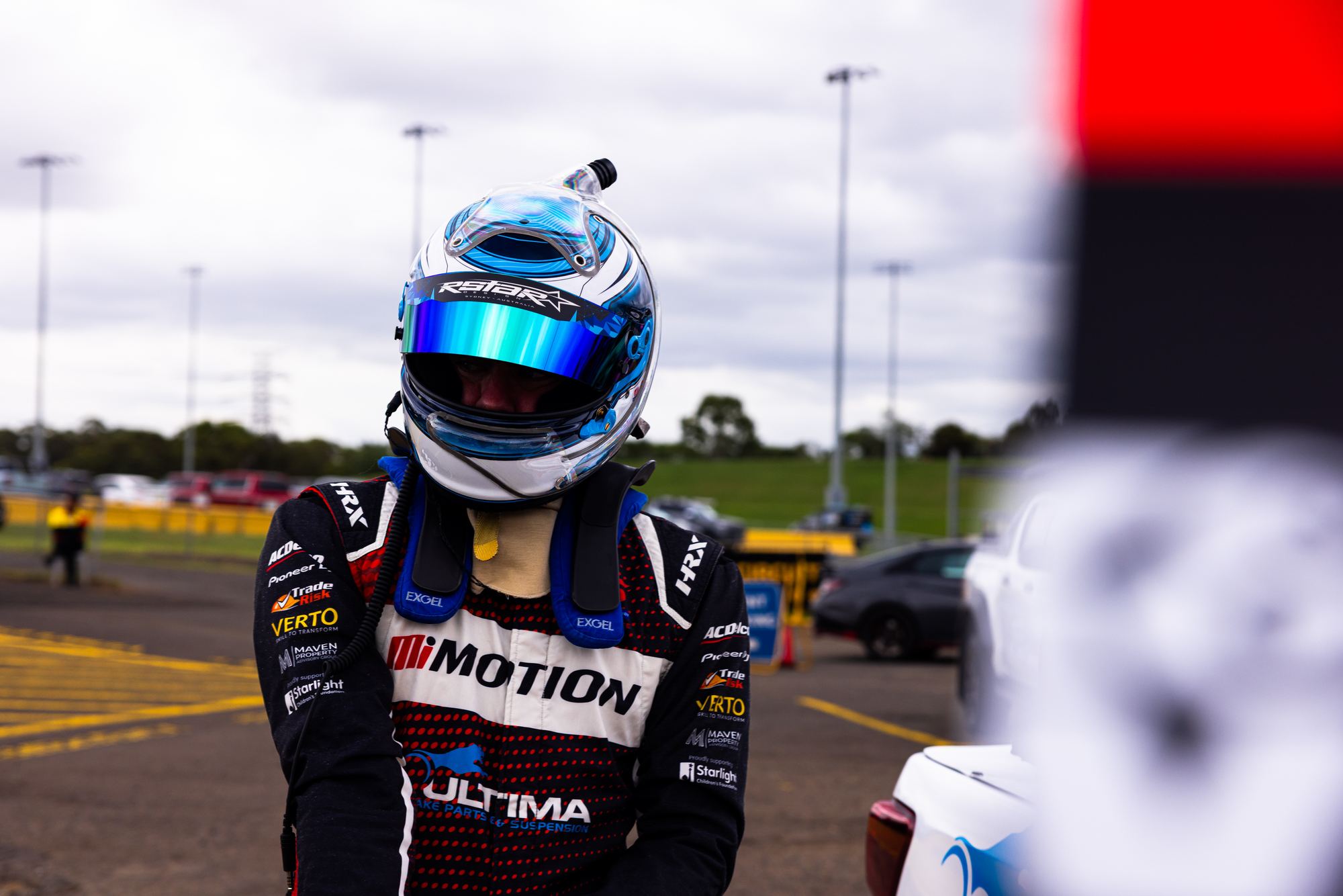 Aaron Borg in his helmet and Team Motion race suit at Sydney Motorsport Park